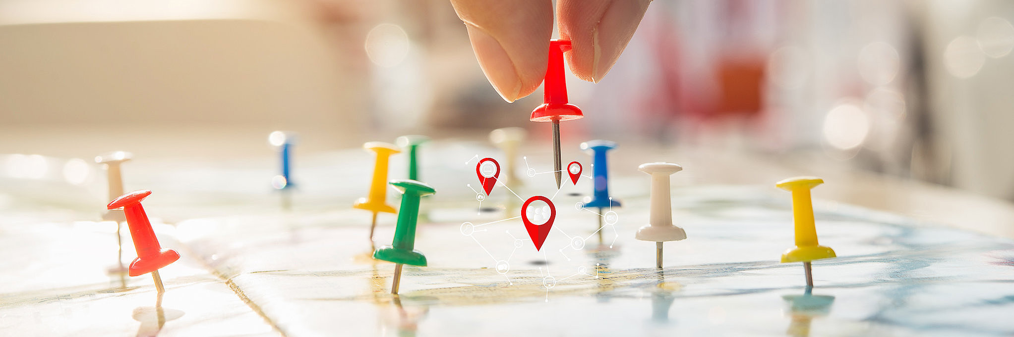 Soft focus hand holding paper pin on blur perspective road map,